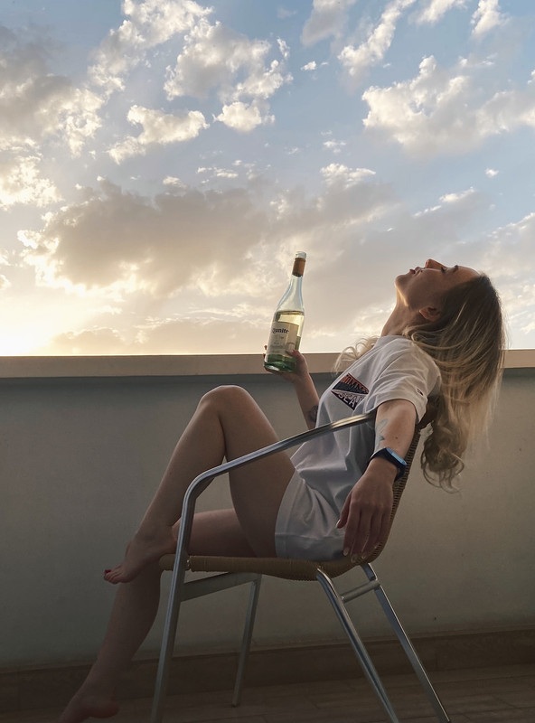 Beauty with a glass of wine on the balcony